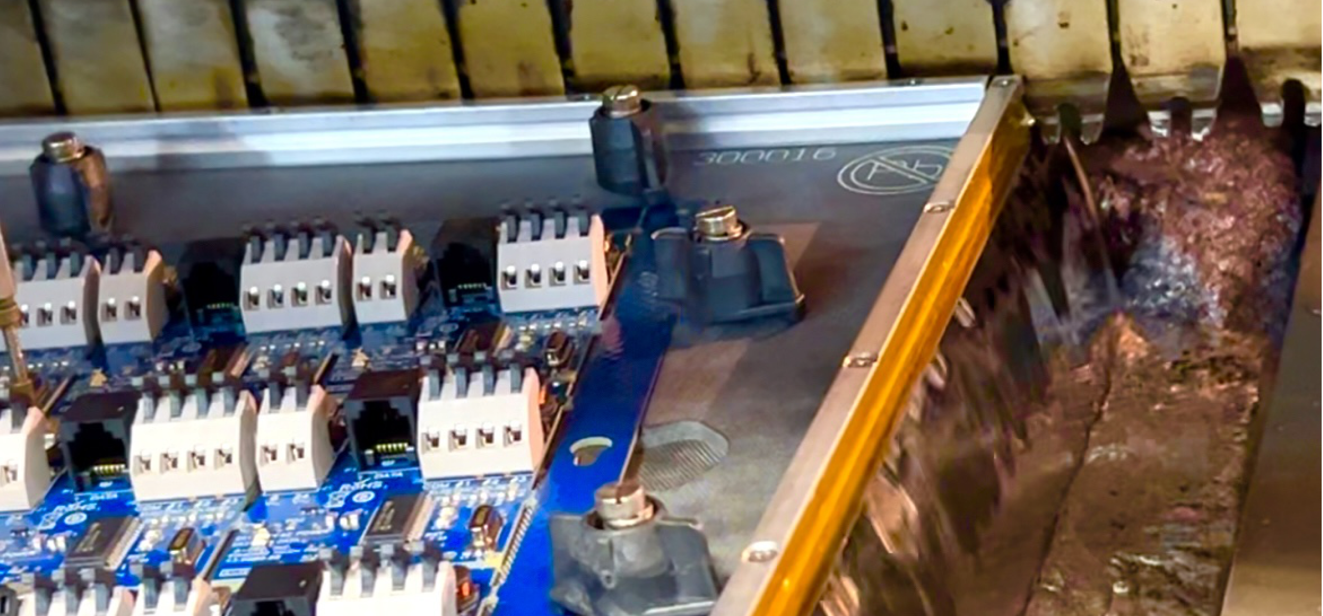 Wave solder machine soldering a circuit board